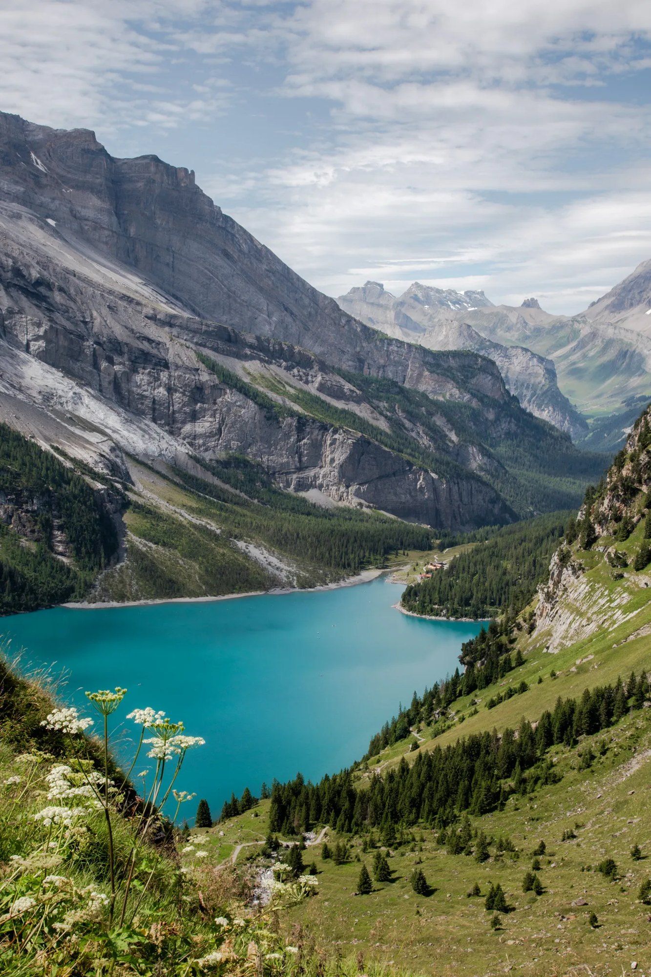A turquoise alpine lake below Swiss mountains